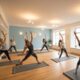 Hot yoga class in a warm studio with diverse students practicing yoga poses